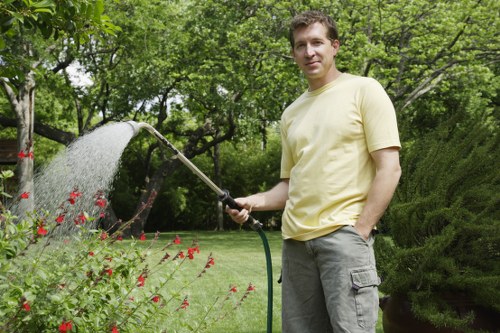 Watering a garden lawn in Mottingham during warm weather